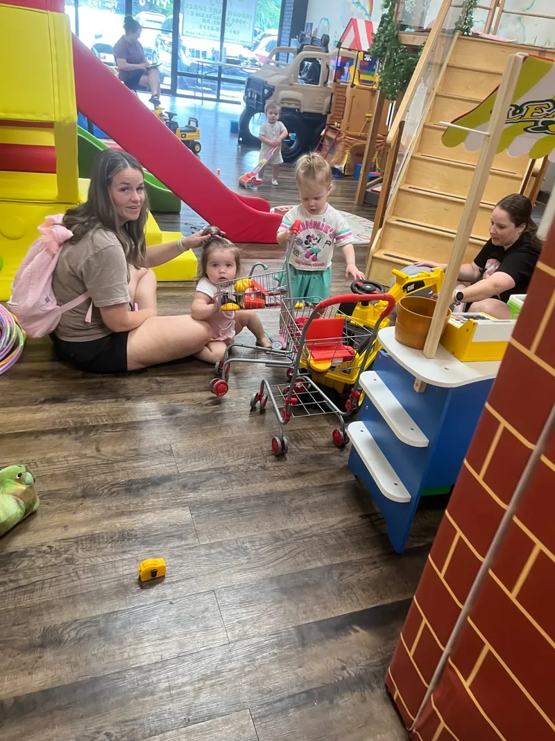 Families sharing imaginative play inside Fresh Play Cafe
