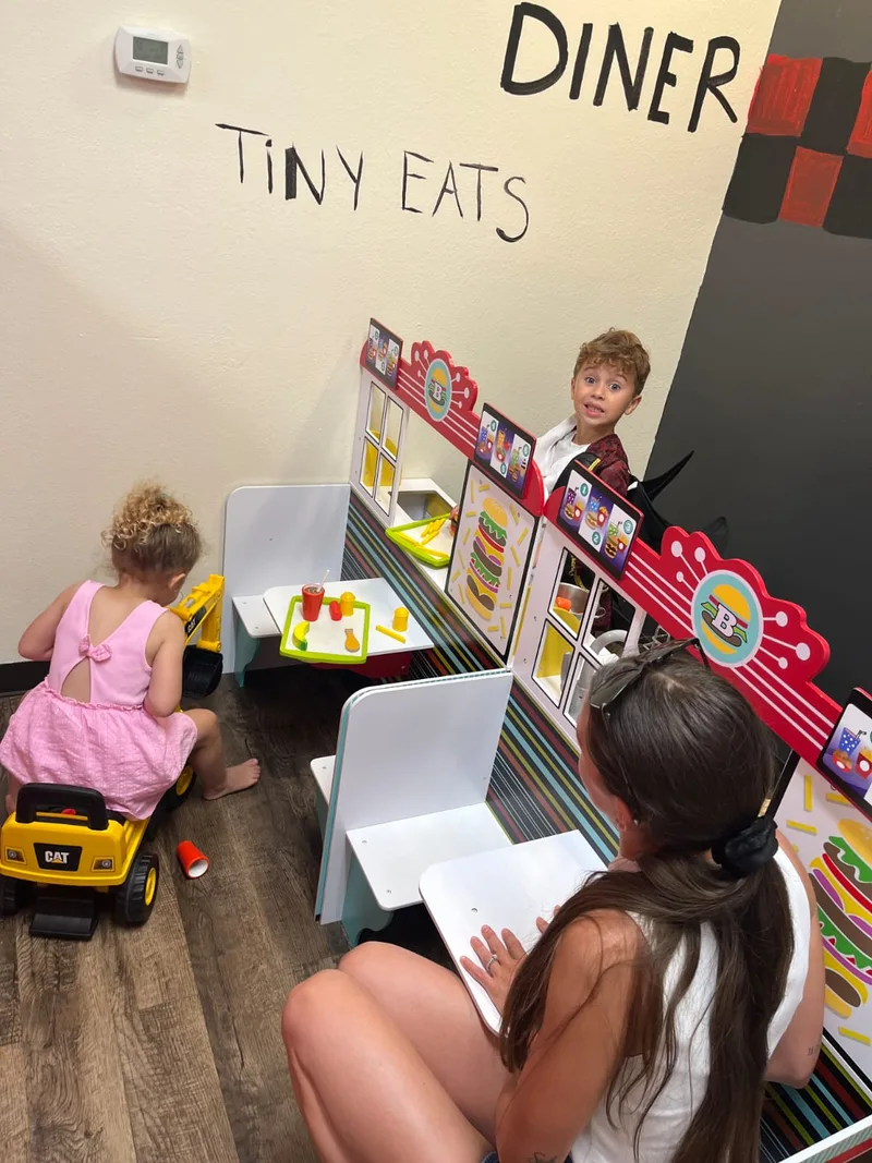 Children enjoying the Tiny Eats pretend diner